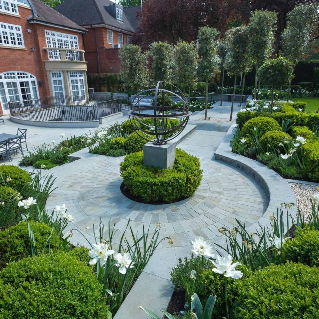 Large contemporary sophisticated garden elegant with multi-level features and staircases to the main terrace outdoor environment a stately, formal look feel.