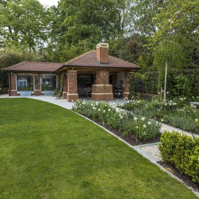 Large contemporary sophisticated garden elegant with multi-level features and staircases to the main terrace outdoor environment a stately, formal look feel.