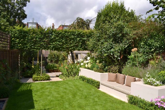 Lovely low maintenance family garden in Putney with raised bed for herbs and edible / culinary plants garden landscape design building company southwest London.