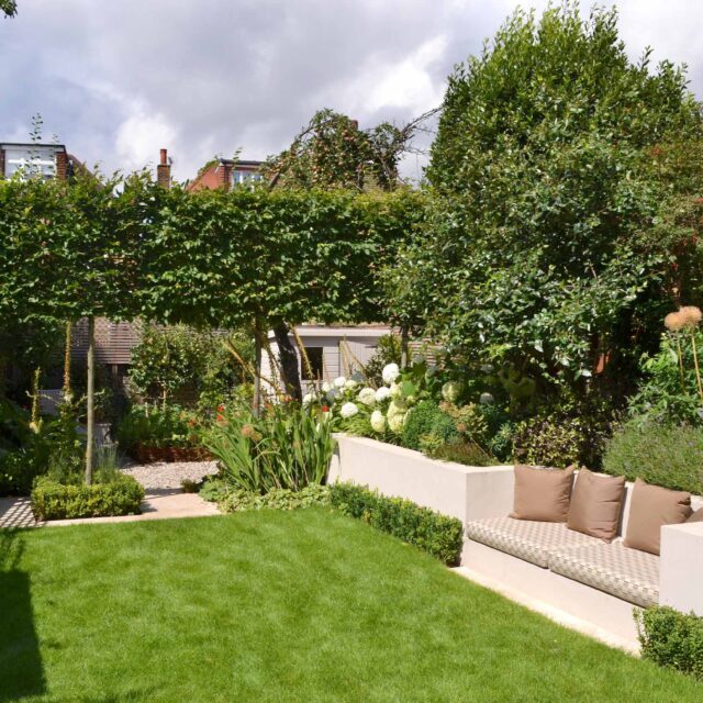 Lovely low maintenance family garden in Putney with raised bed for herbs and edible / culinary plants garden landscape design building company southwest London.
