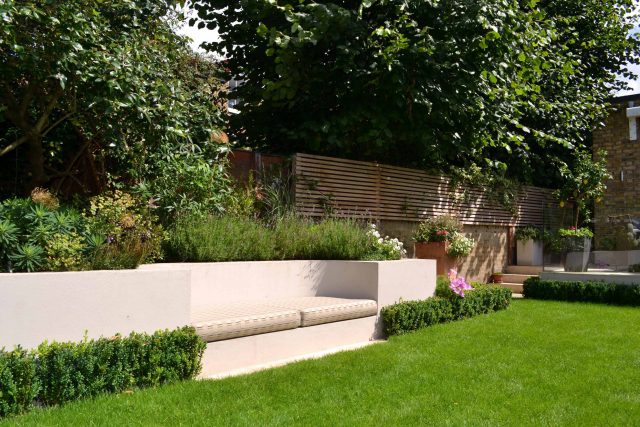 Lovely low maintenance family garden in Putney with raised bed for herbs and edible / culinary plants garden landscape design building company southwest London.