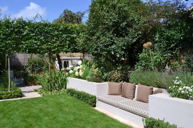 Lovely low maintenance family garden in Putney with raised bed for herbs and edible / culinary plants garden landscape design building company southwest London.