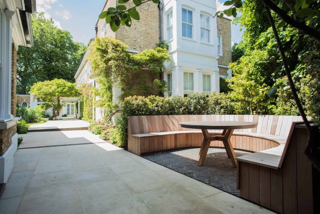 A grand residential garden in Fulham designed and built by The Garden Builders, a relaxing family garden, terrace for fun, outdoor entertainment space with lawn.