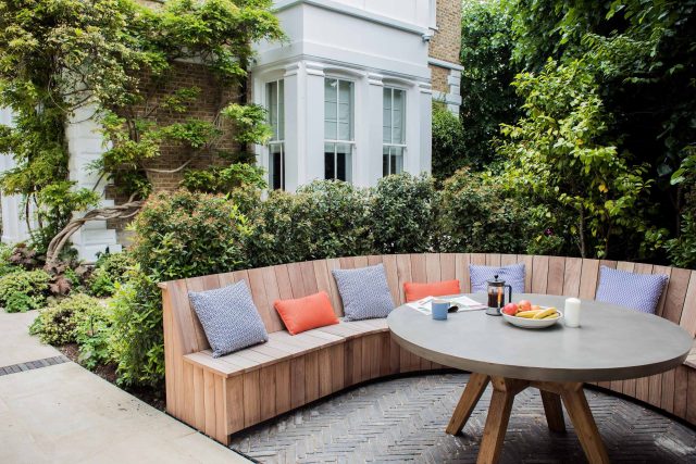 A grand residential garden in Fulham designed and built by The Garden Builders, a relaxing family garden, terrace for fun, outdoor entertainment space with lawn.