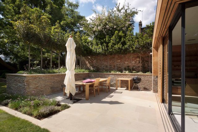 Large Grand Garden design includes York stone and wooden family pavilion in Notting Hill west London Landscape design company Ladbroke Grove Westbourne Grove.