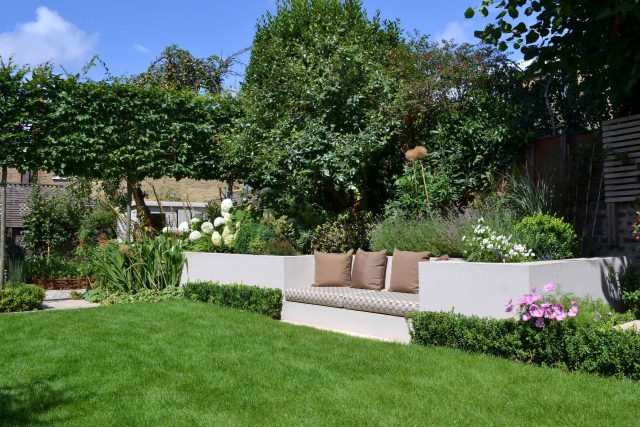 Lovely low maintenance family garden in Putney with raised bed for herbs and edible / culinary plants garden landscape design building company southwest London.
