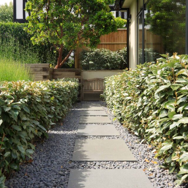 Beautiful town garden in Putney, design Garden landscaping company near me includes black granite stone paving and hard wood gates bespoke gates in hard wood.
