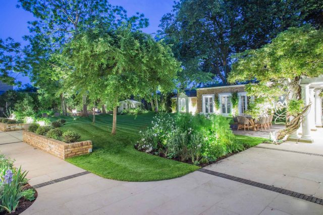 A grand residential garden in Fulham designed and built by The Garden Builders, a relaxing family garden, terrace for fun, outdoor entertainment space with lawn.
