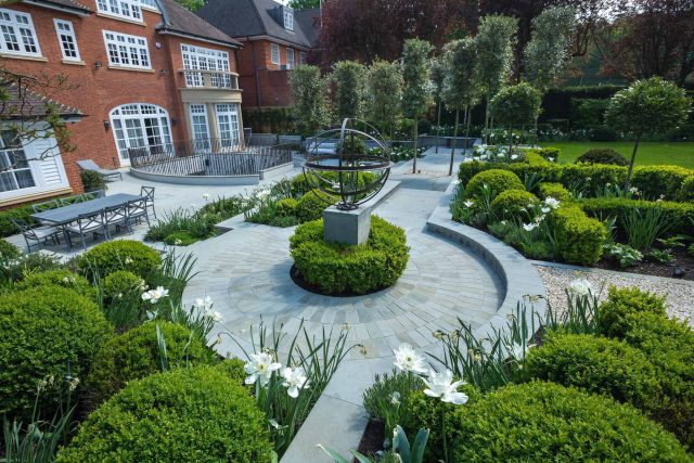 Large contemporary sophisticated garden elegant with multi-level features and staircases to the main terrace outdoor environment a stately, formal look feel.