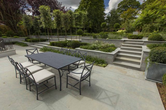 Large contemporary sophisticated garden elegant with multi-level features and staircases to the main terrace outdoor environment a stately, formal look feel.