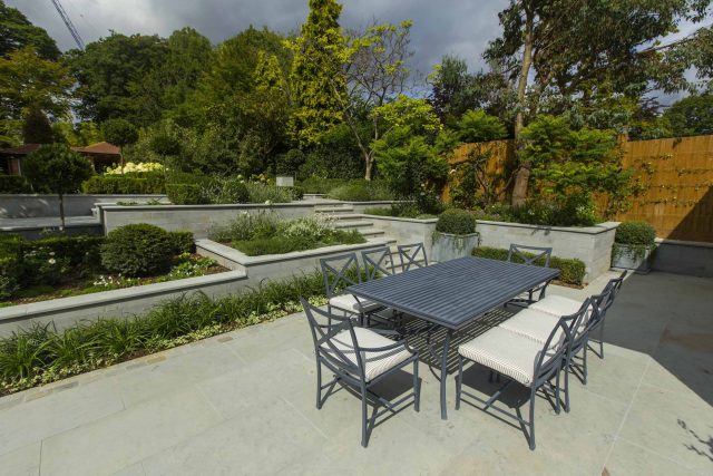 Large contemporary sophisticated garden elegant with multi-level features and staircases to the main terrace outdoor environment a stately, formal look feel.