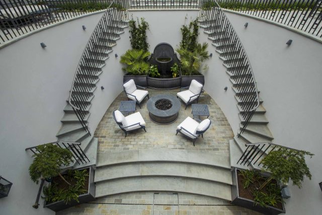 Large contemporary sophisticated garden elegant with multi-level features and staircases to the main terrace outdoor environment a stately, formal look feel.