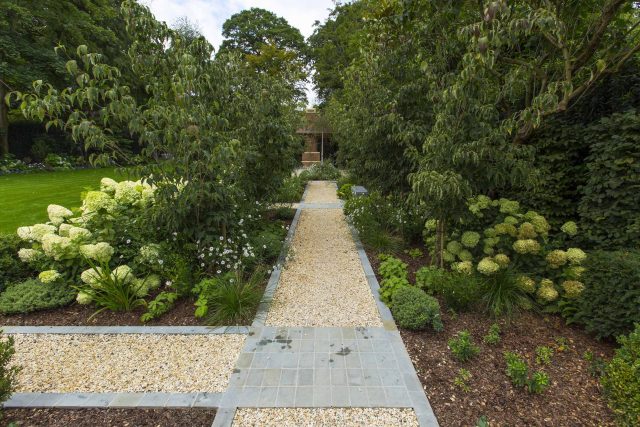 Large contemporary sophisticated garden elegant with multi-level features and staircases to the main terrace outdoor environment a stately, formal look feel.