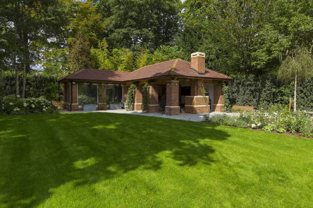 Large contemporary sophisticated garden elegant with multi-level features and staircases to the main terrace outdoor environment a stately, formal look feel.