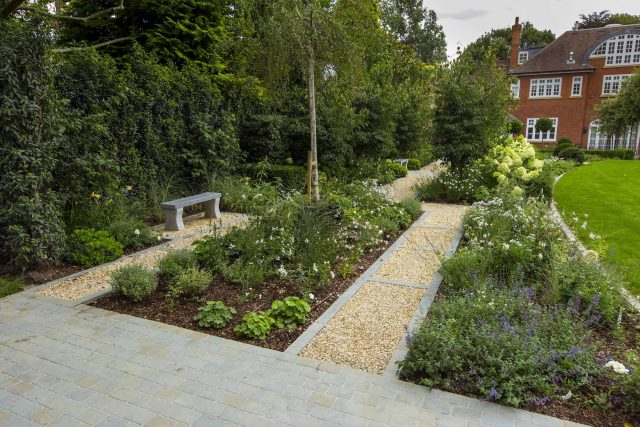 Large contemporary sophisticated garden elegant with multi-level features and staircases to the main terrace outdoor environment a stately, formal look feel.