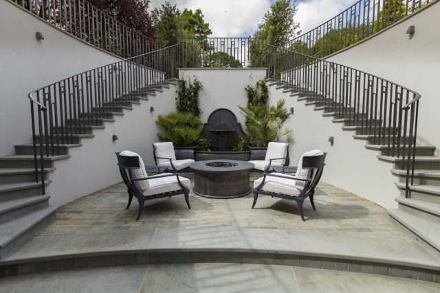 Large contemporary sophisticated garden elegant with multi-level features and staircases to the main terrace outdoor environment a stately, formal look feel.