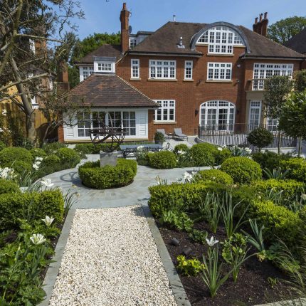 Large contemporary sophisticated garden elegant with multi-level features and staircases to the main terrace outdoor environment a stately, formal look feel.