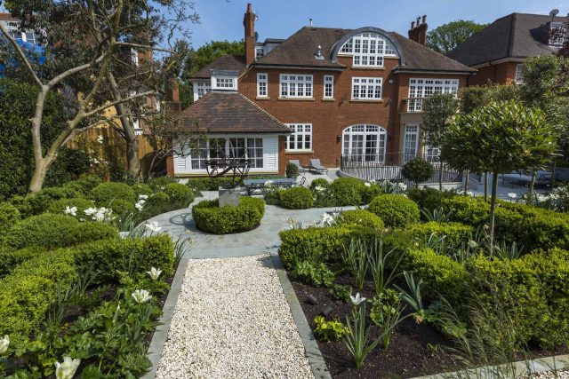 Large contemporary sophisticated garden elegant with multi-level features and staircases to the main terrace outdoor environment a stately, formal look feel.