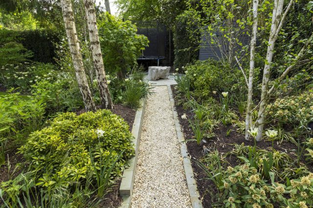 Large contemporary sophisticated garden elegant with multi-level features and staircases to the main terrace outdoor environment a stately, formal look feel.