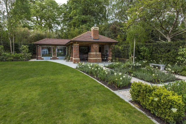 Large contemporary sophisticated garden elegant with multi-level features and staircases to the main terrace outdoor environment a stately, formal look feel.