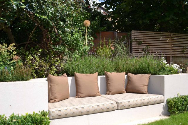 Lovely low maintenance family garden in Putney with raised bed for herbs and edible / culinary plants garden landscape design building company southwest London.