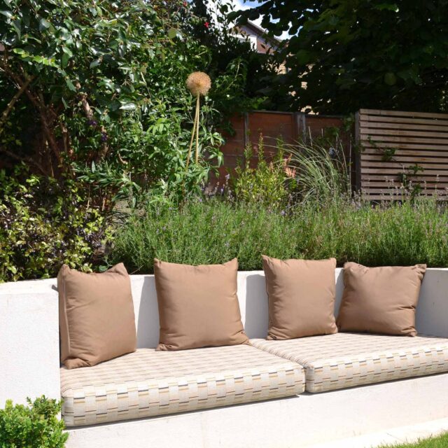 Lovely low maintenance family garden in Putney with raised bed for herbs and edible / culinary plants garden landscape design building company southwest London.