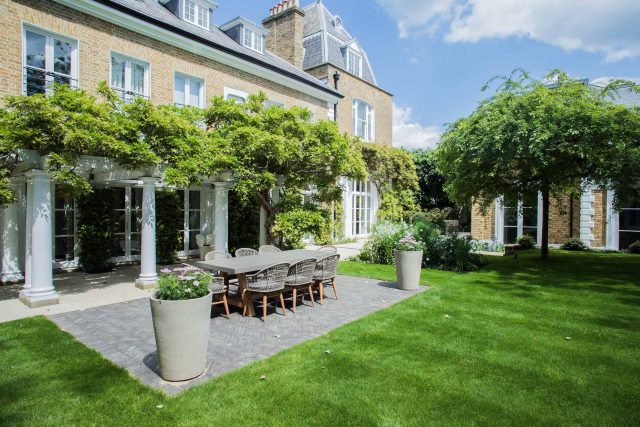 A grand residential garden in Fulham designed and built by The Garden Builders, a relaxing family garden, terrace for fun, outdoor entertainment space with lawn.