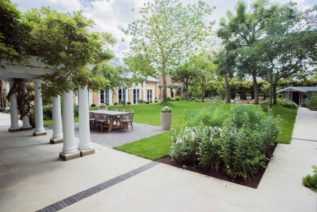 A grand residential garden in Fulham designed and built by The Garden Builders, a relaxing family garden, terrace for fun, outdoor entertainment space with lawn.