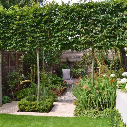 Lovely low maintenance family garden in Putney with raised bed for herbs and edible / culinary plants garden landscape design building company southwest London.