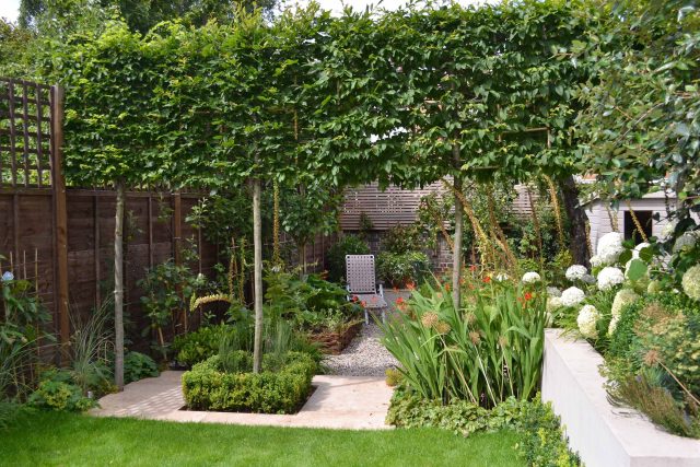 Lovely low maintenance family garden in Putney with raised bed for herbs and edible / culinary plants garden landscape design building company southwest London.