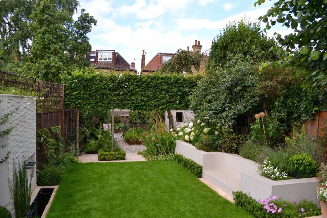 Lovely low maintenance family garden in Putney with raised bed for herbs and edible / culinary plants garden landscape design building company southwest London.