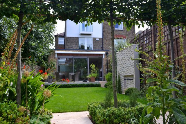 Lovely low maintenance family garden in Putney with raised bed for herbs and edible / culinary plants garden landscape design building company southwest London.
