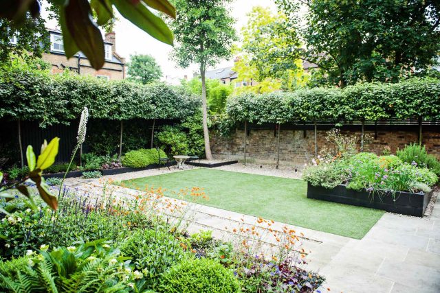Garden with Stone terrace pathways in Wandsworth designed by Sarah Hammond constructed by the Garden Builders, classical high quality finish and low maintenance.