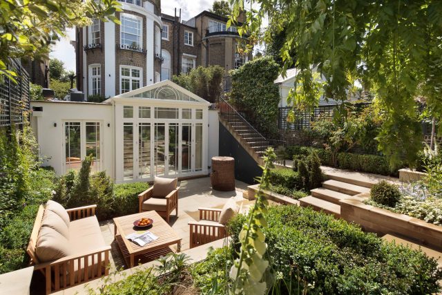 Large Grand Garden design includes York stone and wooden family pavilion in Notting Hill west London Landscape design company Ladbroke Grove Westbourne Grove.