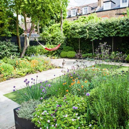 Garden with Stone terrace pathways in Wandsworth designed by Sarah Hammond constructed by the Garden Builders, classical high quality finish and low maintenance.