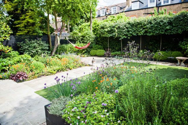Garden with Stone terrace pathways in Wandsworth designed by Sarah Hammond constructed by the Garden Builders, classical high quality finish and low maintenance.