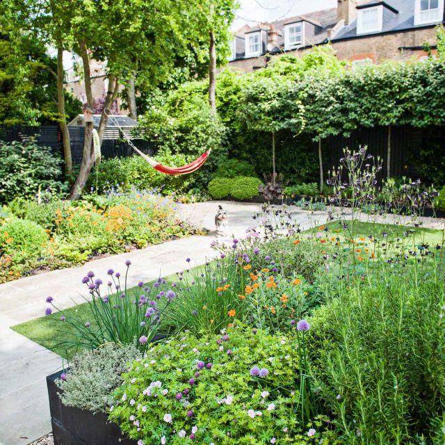 Garden with Stone terrace pathways in Wandsworth designed by Sarah Hammond constructed by the Garden Builders, classical high quality finish and low maintenance.