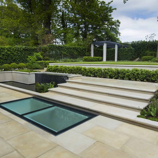 Contemporary landscaped large garden london with pre cast stone paving, led lighting and irrigation, elegant feature step, terrace and basement pool best design.