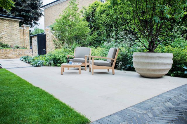A grand residential garden in Fulham designed and built by The Garden Builders, a relaxing family garden, terrace for fun, outdoor entertainment space with lawn.