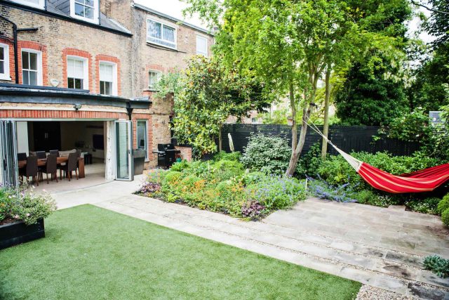 Garden with Stone terrace pathways in Wandsworth designed by Sarah Hammond constructed by the Garden Builders, classical high quality finish and low maintenance.