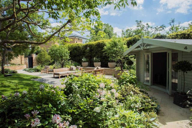 A grand residential garden in Fulham designed and built by The Garden Builders, a relaxing family garden, terrace for fun, outdoor entertainment space with lawn.