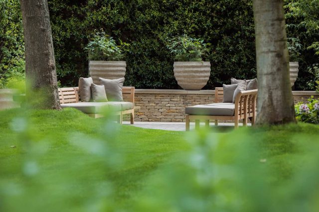 A grand residential garden in Fulham designed and built by The Garden Builders, a relaxing family garden, terrace for fun, outdoor entertainment space with lawn.