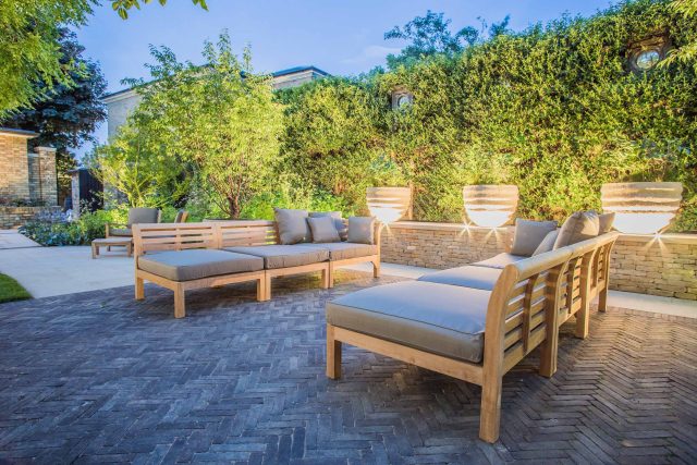 A grand residential garden in Fulham designed and built by The Garden Builders, a relaxing family garden, terrace for fun, outdoor entertainment space with lawn.