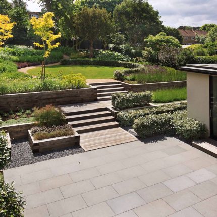 Beautiful town garden in Putney, design Garden landscaping company near me includes black granite stone paving and hard wood gates bespoke gates in hard wood.