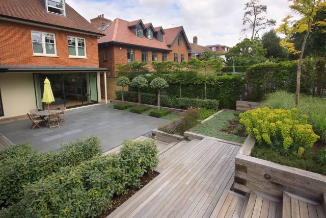 Beautiful town garden in Putney, design Garden landscaping company near me includes black granite stone paving and hard wood gates bespoke gates in hard wood.