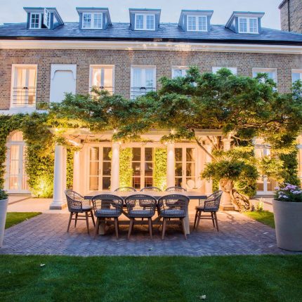 A grand residential garden in Fulham designed and built by The Garden Builders, a relaxing family garden, terrace for fun, outdoor entertainment space with lawn.