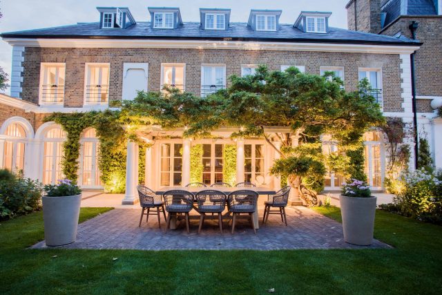 A grand residential garden in Fulham designed and built by The Garden Builders, a relaxing family garden, terrace for fun, outdoor entertainment space with lawn.