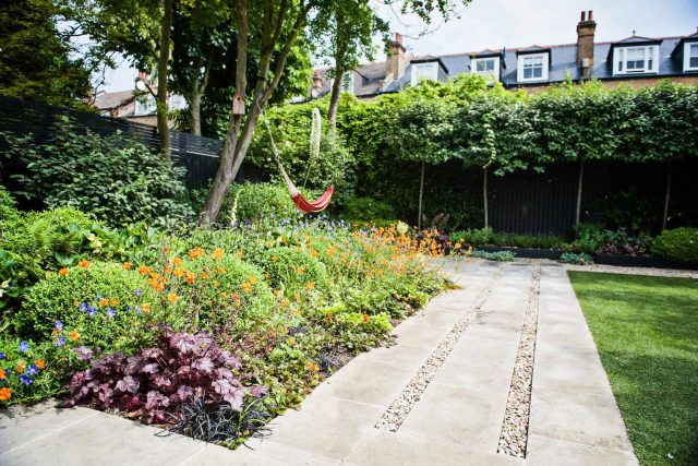 Garden with Stone terrace pathways in Wandsworth designed by Sarah Hammond constructed by the Garden Builders, classical high quality finish and low maintenance.