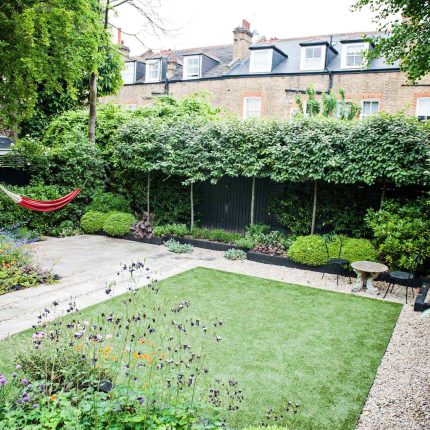 Garden with Stone terrace pathways in Wandsworth designed by Sarah Hammond constructed by the Garden Builders, classical high quality finish and low maintenance.