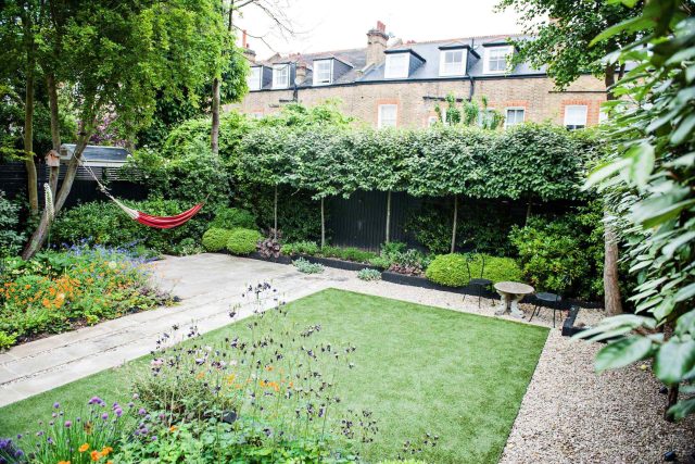 Garden with Stone terrace pathways in Wandsworth designed by Sarah Hammond constructed by the Garden Builders, classical high quality finish and low maintenance.